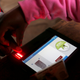 An IEBC official uses an electronic voter identification machine to check a voters' status at a polling station during a presidential election re-run in Nairobi, Kenya October 26, 2017.